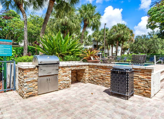 a brick patio with a barbecue grill and two stainless steel appliances at Waterford Park Apartment Homes, LLC, Florida, 33319