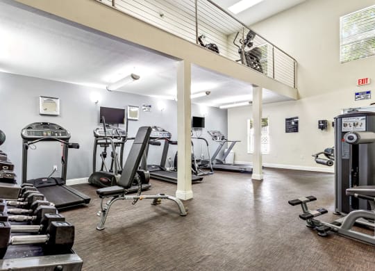 the gym has plenty of exercise equipment at the enclave at university heights apartments at Waterford Park Apartment Homes, LLC, Lauderhill