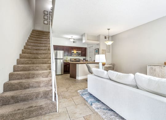 the living room and stairs leading to the kitchen and dining area at Waterford Park Apartment Homes, LLC, Lauderhill