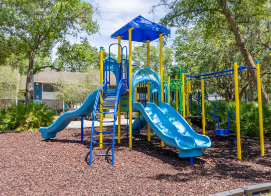 a playground with a blue and yellow play set  at Fisherman's Landing Apartment Homes, Tampa, FL