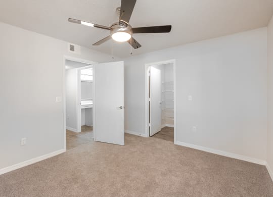 an empty living room with a ceiling fan and a closet  at Fisherman's Landing Apartment Homes, Tampa, 33637