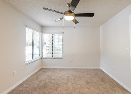 an empty living room with a ceiling fan and a window  at Fisherman's Landing Apartment Homes, Tampa, 33637