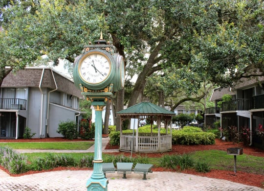 a clock in the middle of a park with a gazebo at Greenwich Commons Apartment Homes, Tampa, FL, 33613