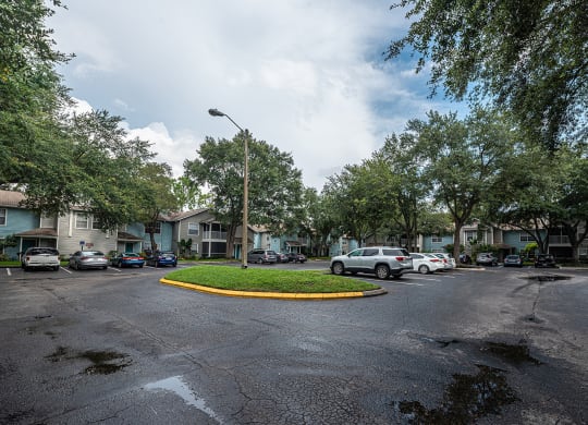 a city street with cars parked in front of houses at Madison Oaks Apartment Homes, LLC, Palm Harbor, FL