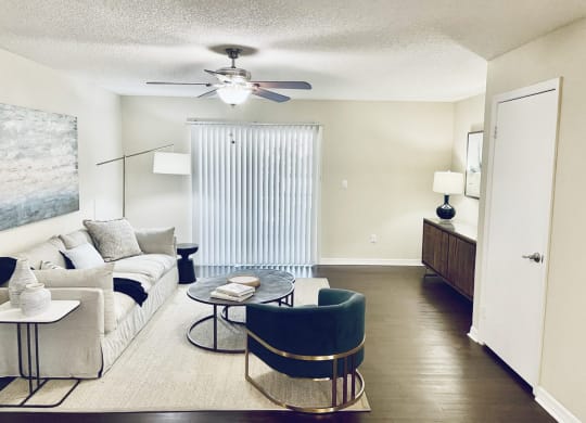 a living room with a couch and a ceiling fan at Madison Oaks Apartment Homes, LLC, Palm Harbor