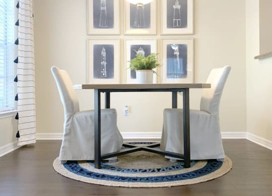a dining room with a table and chairs and a rug at Madison Oaks Apartment Homes, LLC, Florida, 34684