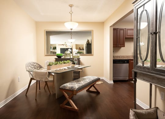 a dining room and kitchen with a table and chairs at Madison Oaks Apartment Homes, LLC, Palm Harbor, FL 34684