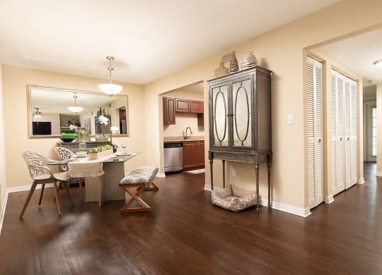 the view of a living room and dining room with a table and chairs at Madison Oaks Apartment Homes, LLC, Palm Harbor