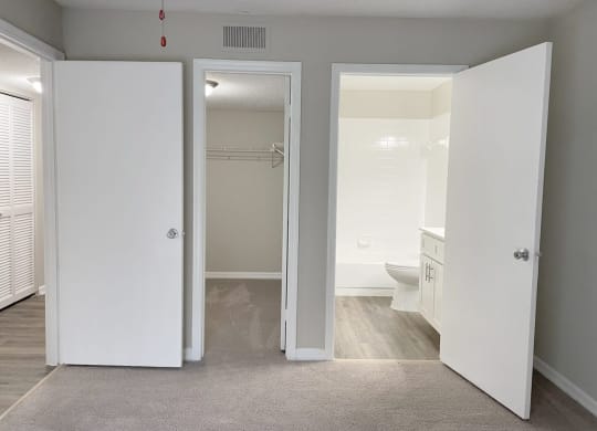 a bedroom with a bathroom and a closet at Madison Oaks Apartment Homes, LLC, Palm Harbor, 34684