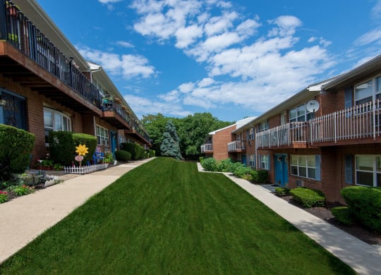 a green lawn in front of some apartments at Raritan Crossing Apartment Homes, New Brunswick, NJ 08901
