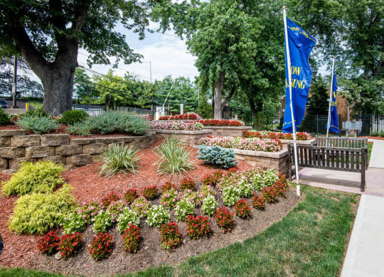 a park with a bench and a flower garden at Raritan Crossing Apartment Homes, New Brunswick New Jersey