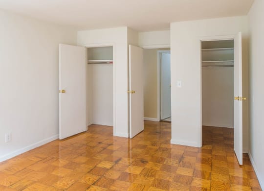 a empty room with four closets and a wooden floor at Raritan Crossing Apartment Homes, New Brunswick