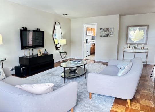 a living room with two couches and a tv at Raritan Crossing Apartment Homes, New Jersey