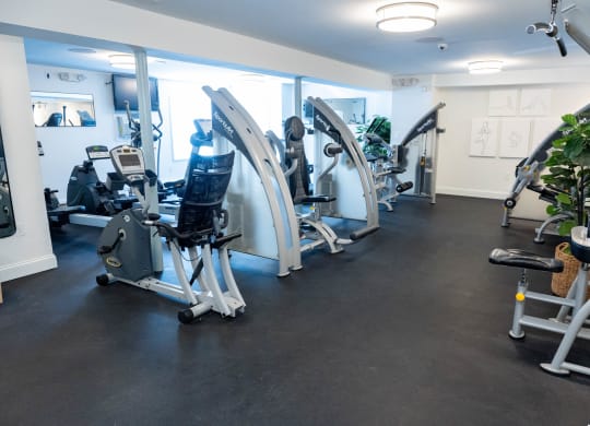 a gym with cardio machines and weights on the floor at Raritan Crossing Apartment Homes, New Brunswick New Jersey