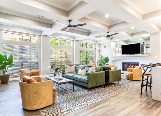a living room with couches and chairs and a fireplace at Hidden Palms Apartment Homes, Tampa, Florida