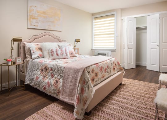 a bedroom with a bed and a window and a rug at Aspen Grove Apartment Homes, Warminster Pennsylvania