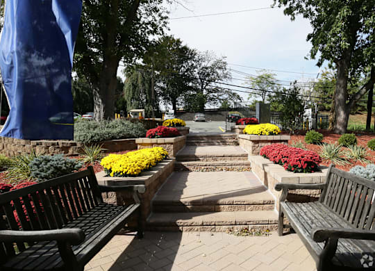 A park with benches and flower beds.