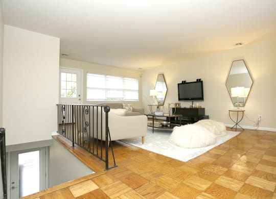 A living room with a white couch and a television.