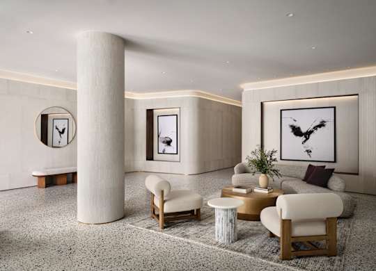 A modern living room with a large abstract painting on the wall.