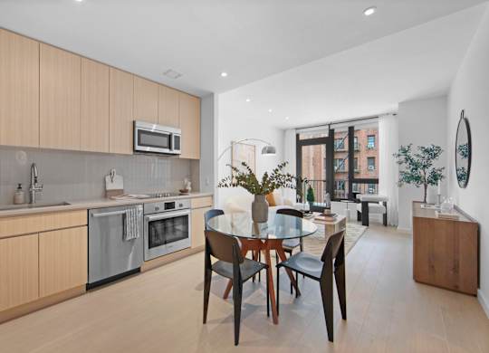 A modern kitchen with a dining table and chairs.