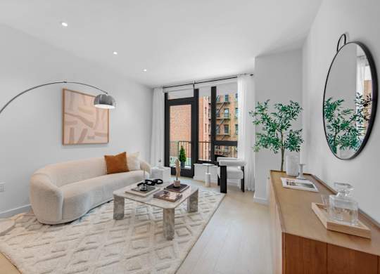 A modern living room with a white couch and a coffee table.
