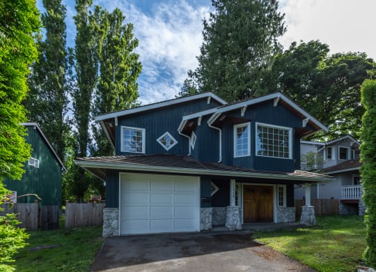 a house with a blue exterior and a white garage door