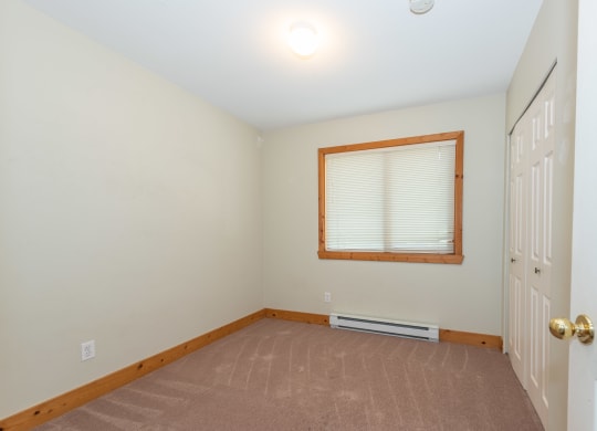a bedroom with a window and a door