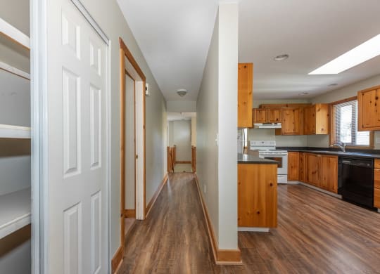 a bedroom with a large window next to a kitchen