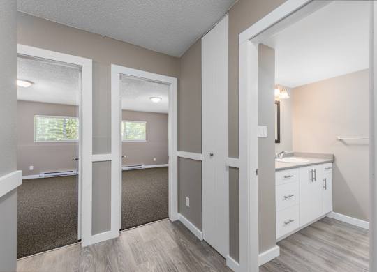 A room with white walls and a brown carpet.