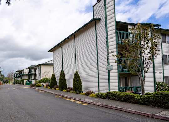 A street view of a residential area with apartment buildings.
