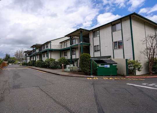 A street view of a residential area with apartment buildings on the side.