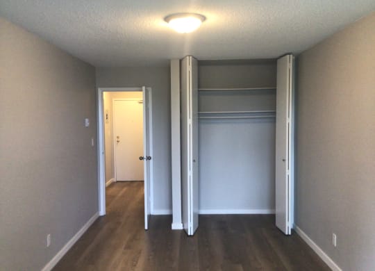 an empty room with a closet and a light on