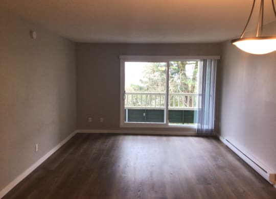 an empty living room with a large window