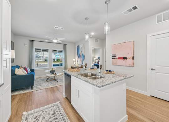 A kitchen with a blue couch and a painting on the wall.at Allegra at Cocoa in Cocoa, FL, 32926