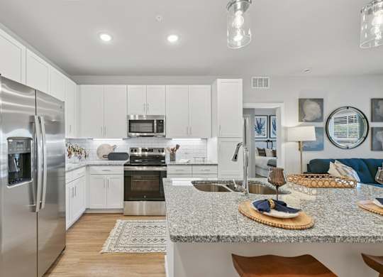 A modern kitchen with a refrigerator, sink, and oven.at Allegra at Cocoa in Cocoa, FL, 32926