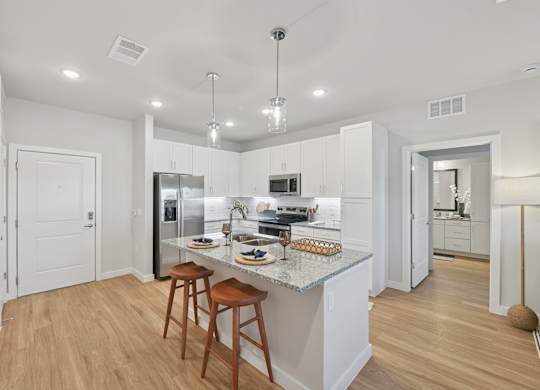 A kitchen with a white countertop and wooden floors.at Allegra at Cocoa in Cocoa, FL, 32926