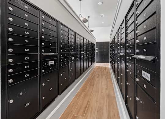 A long hallway with black mailboxes on both sides. at Allegra at Cocoa in Cocoa, FL, 32926