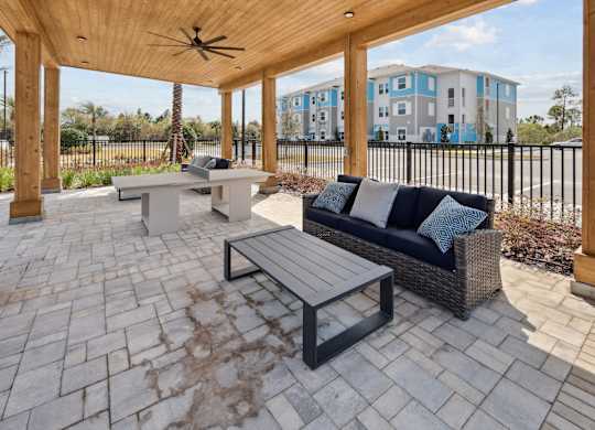 A patio with a couch and a table. at Allegra at Cocoa in Cocoa, FL, 32926