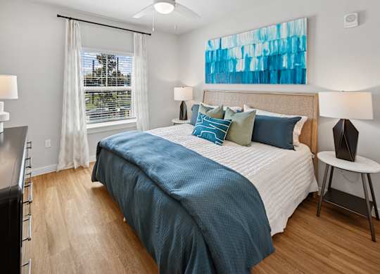 A bedroom with a large bed and a window with curtains. at Allegra at Cocoa in Cocoa, FL, 32926