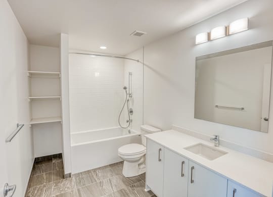 a bathroom with a shower and a sink and a toilet
