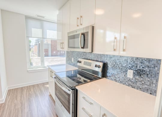 the preserve at ballantyne commons apartment kitchen with stove and microwave