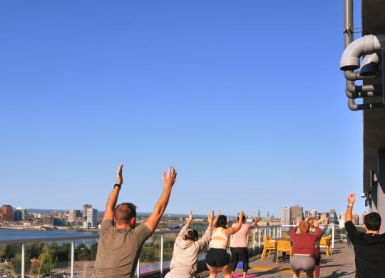 a group of people with their hands in the air at the top of a tower