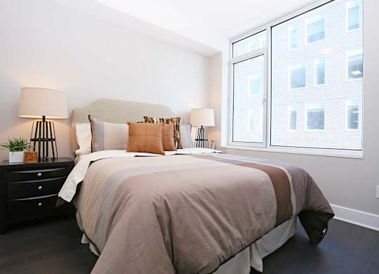 a bedroom with a large bed and a window