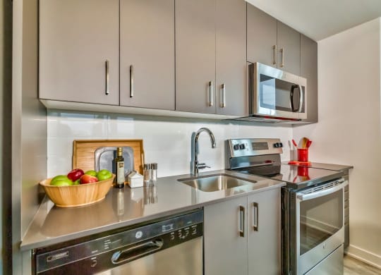 a small kitchen with stainless steel appliances and a sink