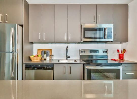 a modern kitchen with stainless steel appliances and stainless steel cabinets