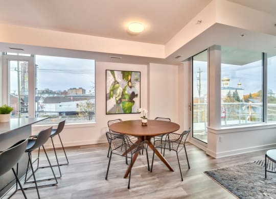 a dining room with a table and chairs and a large window