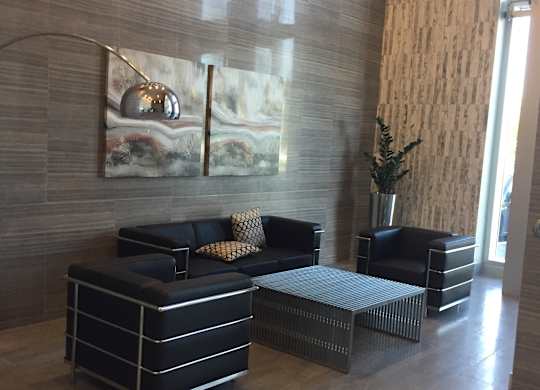 a living room with couches and a table and a lamp