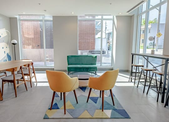 a seating area with a table and chairs in a lobby