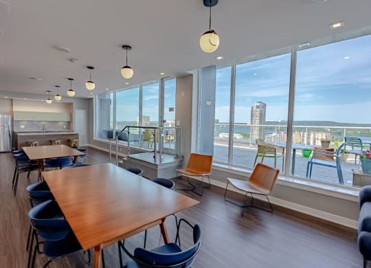 a dining room with a view of a city and a table and chairs