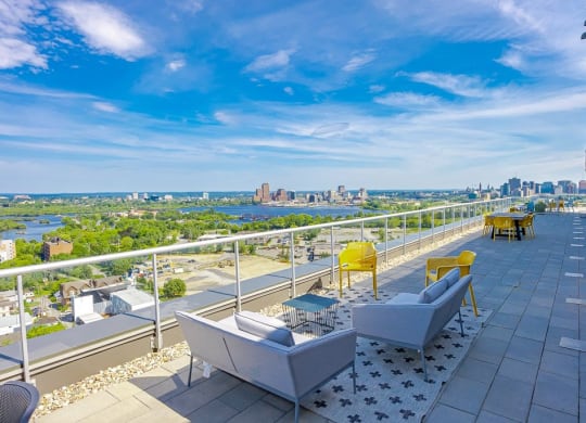 a balcony with a view of the city and a blue sky